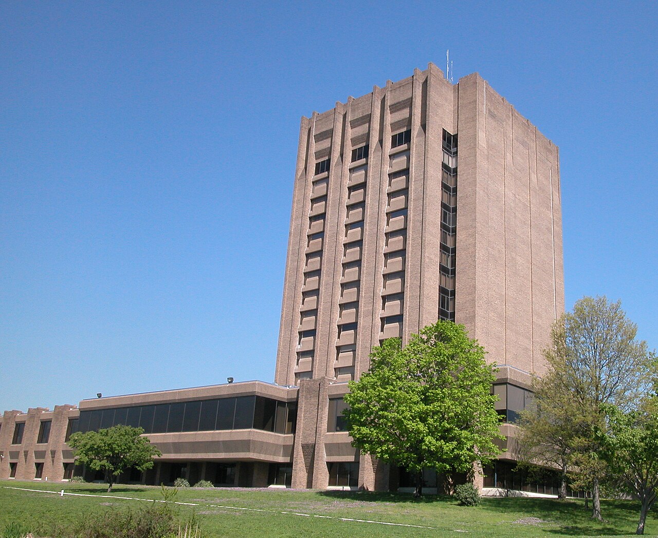 The USDA National Agricultural Library building in Beltsville, Maryland, photographed from below against a clear sky.
