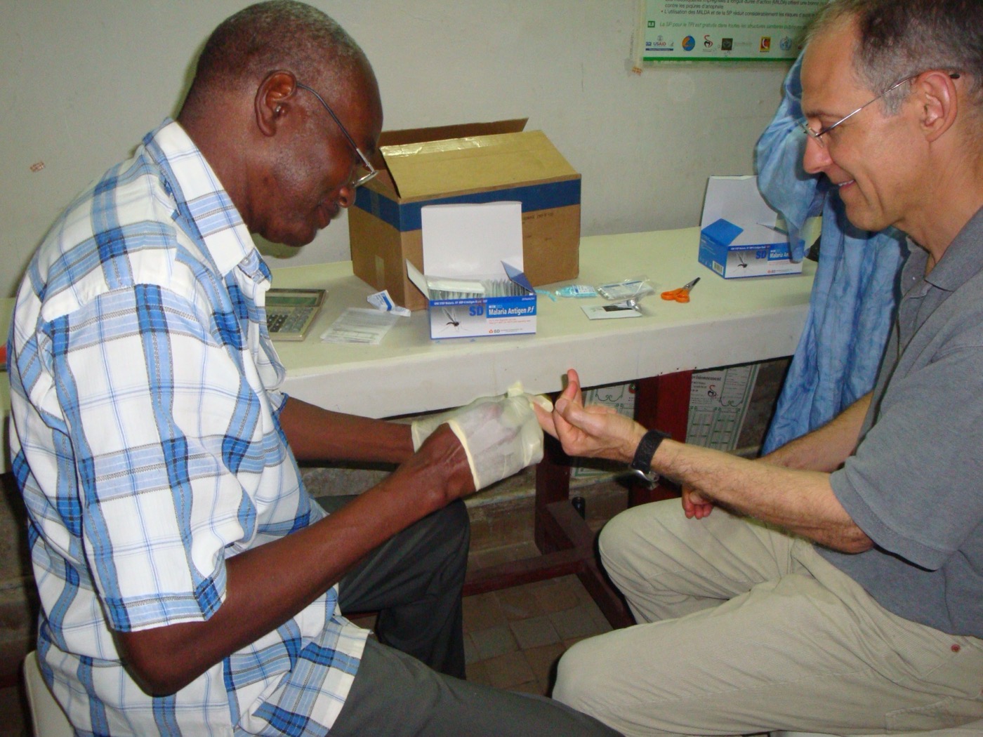 Moussa Diagne, an entomologist with Senegal's Parasite Control Service, administers a malaria rapid diagnostic test to a patient.